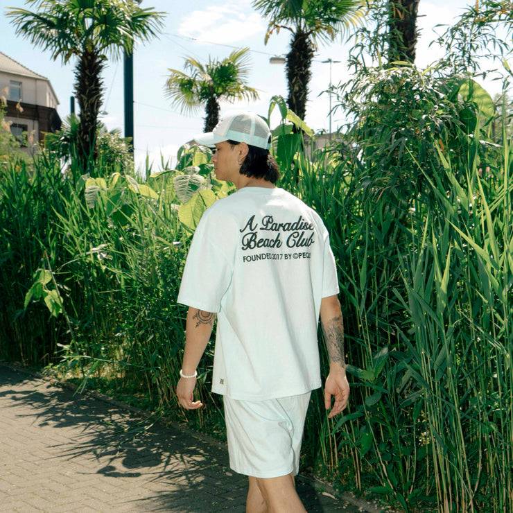 Pequs A Paradise Beach Club Back Logo T-Shirt Neueste Stile